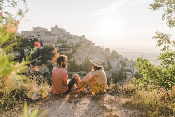 Couple overlooking a European village while slow traveling