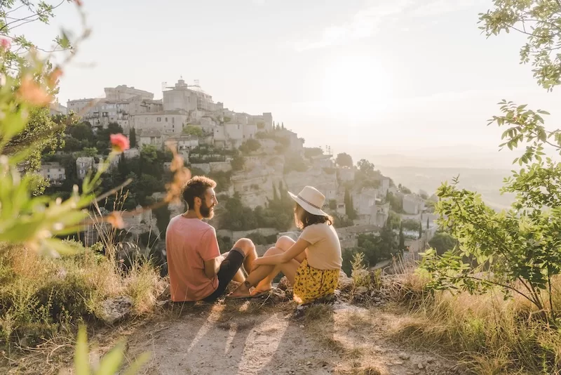 Couple overlooking a European village while slow traveling