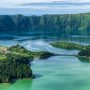 Volcanic crater lake in the Azores surrounded by green hills and forest