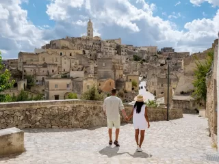 Couple walking through the historic streets of Matera, Italy
