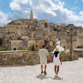 Couple walking through the historic streets of Matera, Italy