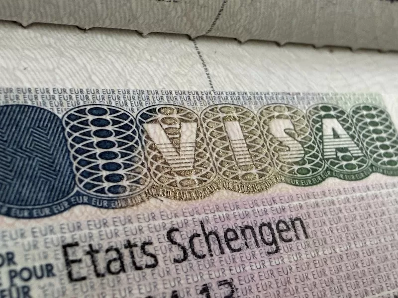 Schengen visa displayed inside an international passport