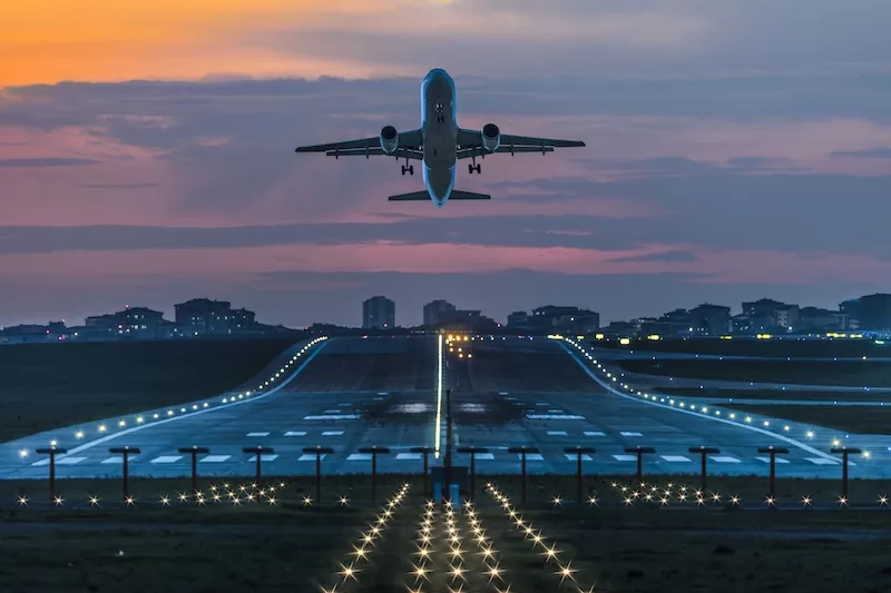 Passenger airplane departing from a European airport at dusk