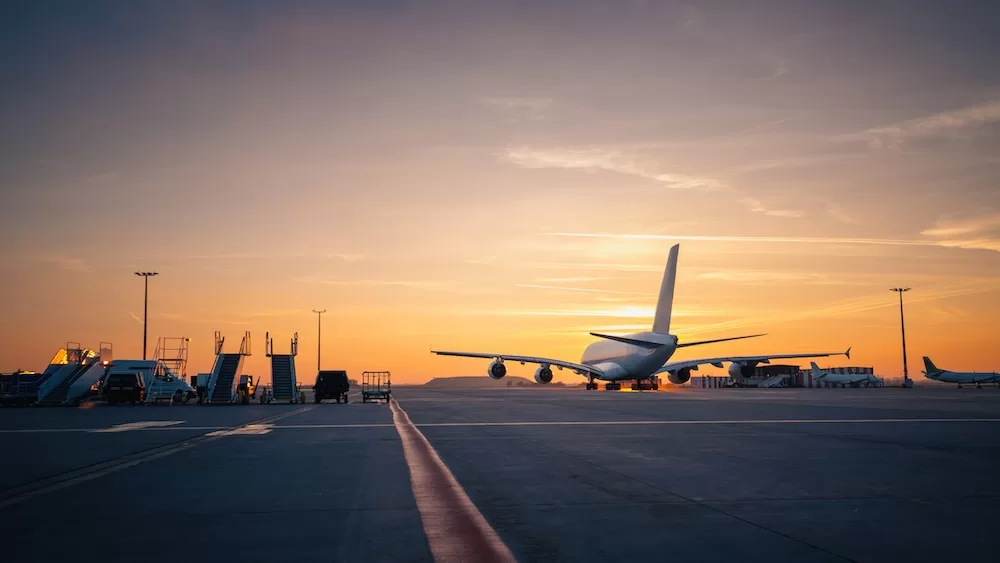International airplane at an airport during sunset