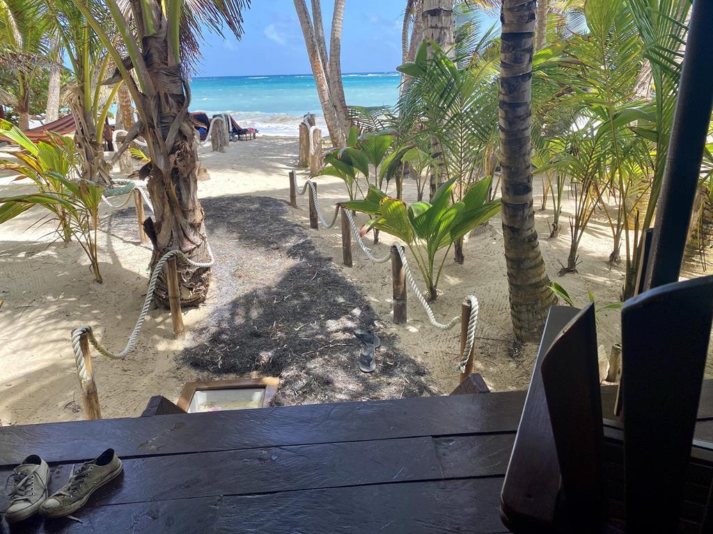 Sandy path from a resort bungalow leading to the Caribbean Sea