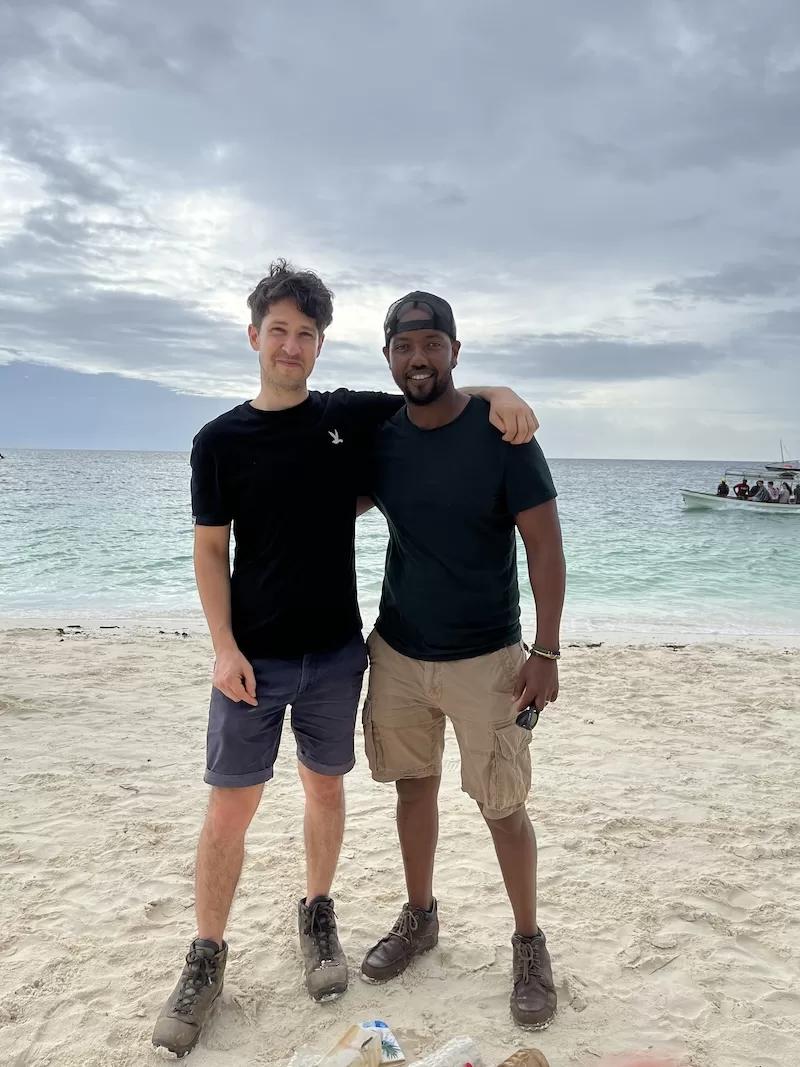 Two friends standing together on Kendwa Beach in Zanzibar.
