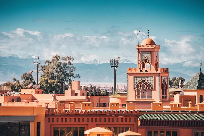 Traditional Marrakech architecture with the Atlas Mountains in the distance
