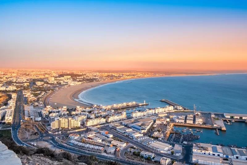 Aerial view of Moroccan coastal city and marina at sunset