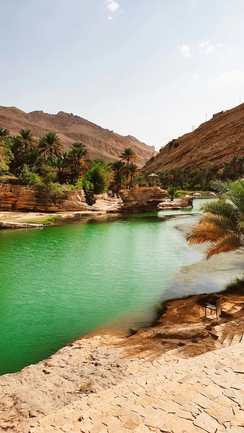 Rugged Omani coastline with turquoise water and rocky islands