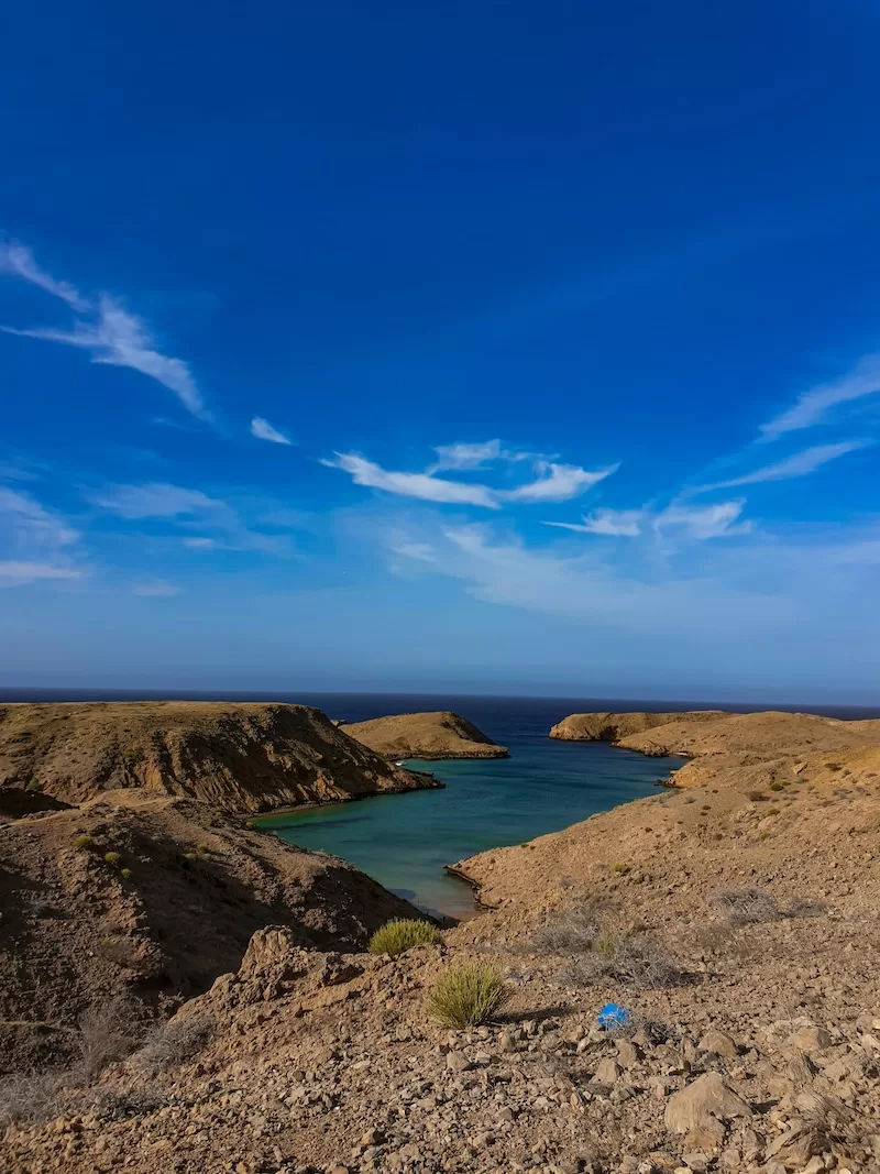 Rocky canyon and clear water pool in the Omani desert