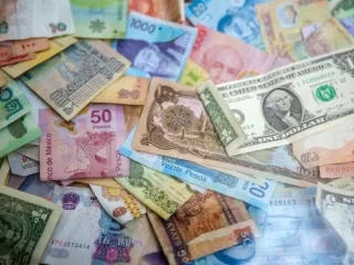 International banknotes showing currency exposure when buying property abroad