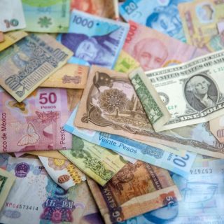 International banknotes showing currency exposure when buying property abroad