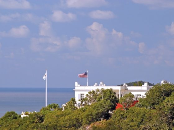 US flag flying above a coastal official residence