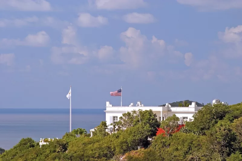 US flag flying above a coastal official residence