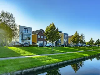 Modern residential homes beside a canal in a quiet property market