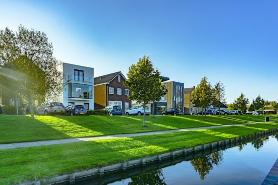 Modern residential homes beside a canal in a quiet property market