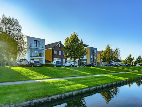 Modern residential homes beside a canal in a quiet property market