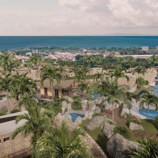 Aerial rendering of Liyongo village resort on Zanzibar’s North Coast with villas, pools, palm trees, and ocean views