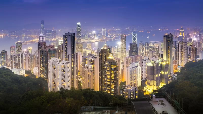 Hong Kong skyline at night representing urban density and high life expectancy