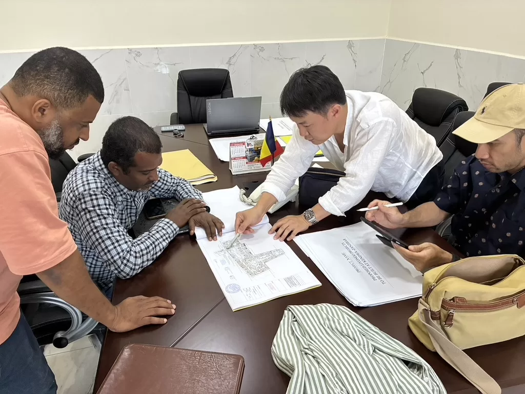Liyongo project team reviewing a resort site plan on a screen during a planning meeting
