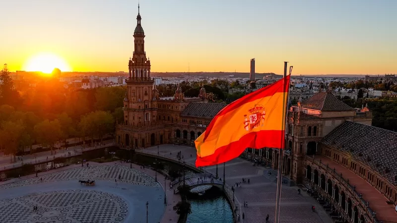 Spanish flag over Seville representing Spain’s rising longevity rankings