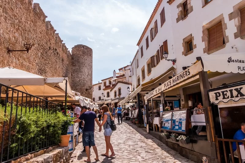 Restaurants and medieval stone walls in Tossa de Mar, Catalonia