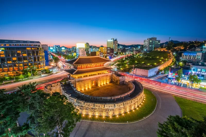 Seoul city skyline and historic gate representing South Korea’s rapid gains in life expectancy