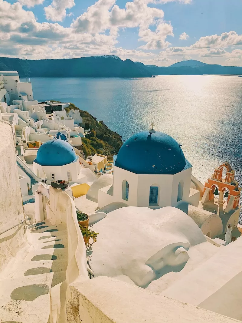 Blue-domed churches overlooking the Aegean Sea in Oia, Santorini, Greece