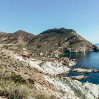 Hiker walking along a rugged coastal trail in Andalusia overlooking the Mediterranean Sea