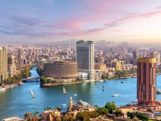 Cairo skyline and Nile River with boats and high-rise buildings