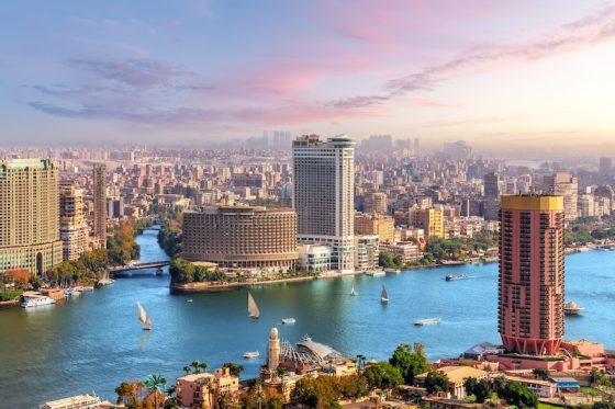 Cairo skyline and Nile River with boats and high-rise buildings