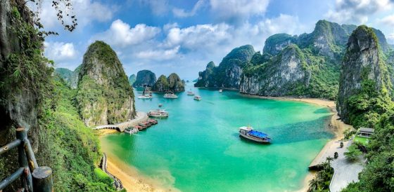 Turquoise bay with tour boats surrounded by limestone karst formations in Ha Long Bay, Vietnam