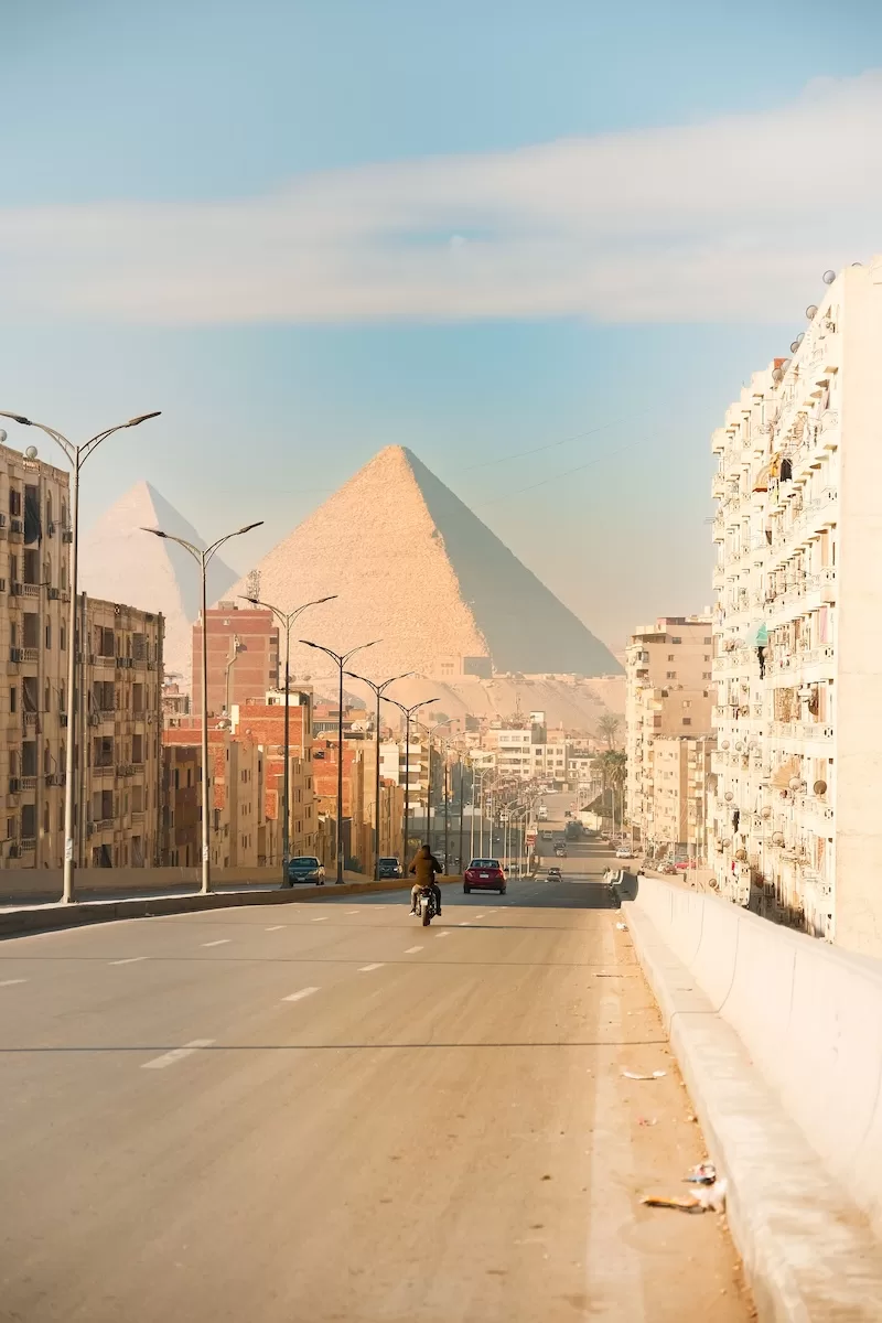 Cairo residential street with the Pyramids of Giza in the background