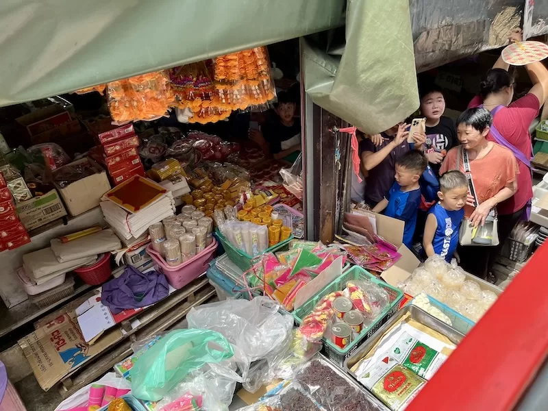 Busy local market stall with shoppers in Bangkok, Thailand
