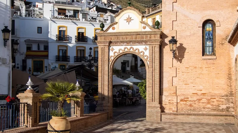 Brick archway and traditional architecture in a white Andalusian village