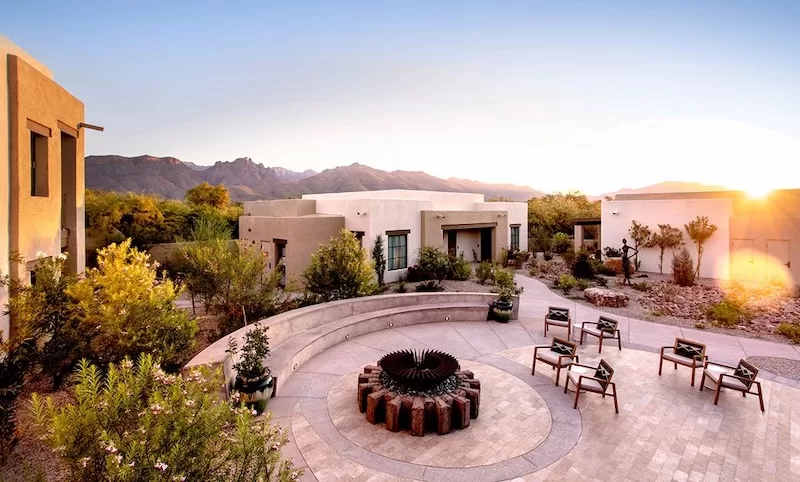Canyon Ranch Tucson courtyard and fire pit at sunset with the Santa Catalina Mountains behind