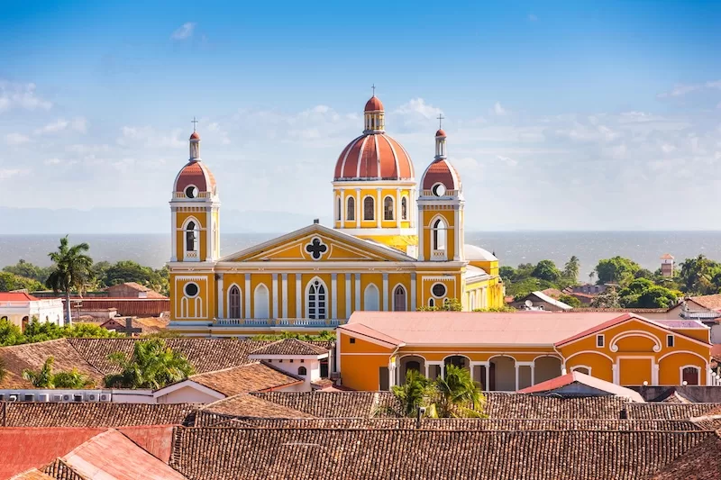 The yellow cathedral of Granada, Nicaragua, above the city rooftops and Lake Nicaragua