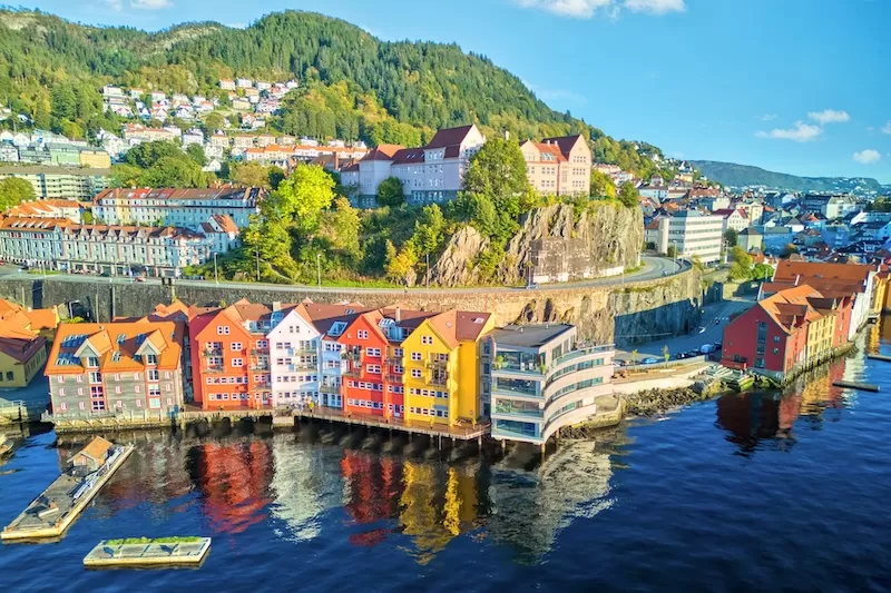 Coloured timber warehouses along the Bergen waterfront in Norway, one of the coolcation destinations in Europe that gained visitors this summer
