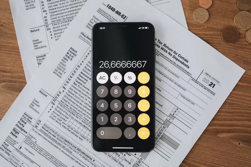 US tax forms and a calculator, showing why a digital nomad visa does not switch off American tax