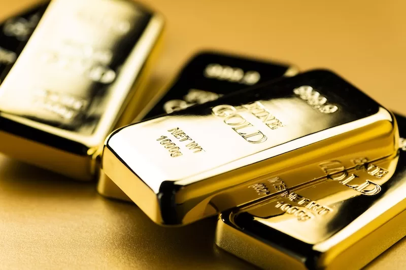 Stacked one kilogram fine gold bullion bars