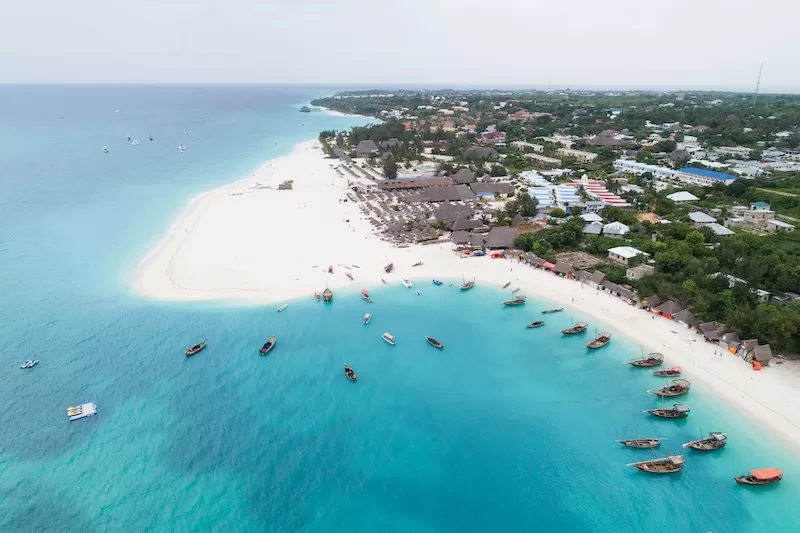 Aerial view of Kendwa beach on Zanzibar’s northwest coast, with dhow boats moored in shallow turquoise water