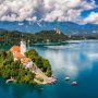 The island church and Bled Castle on Lake Bled, Slovenia, with the Julian Alps behind