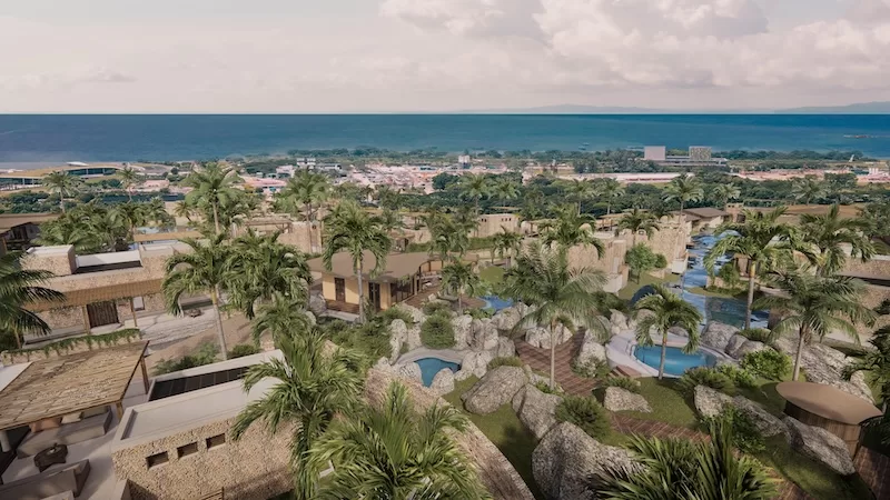 Aerial render of Liyongo at Kendwa, Zanzibar, showing low-rise villas, gardens and pools set back from the beach