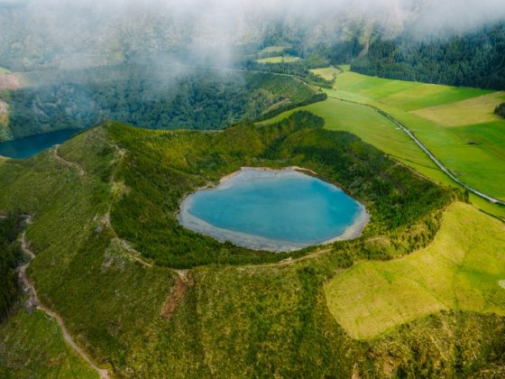 A blue crater lake among green hills on São Miguel in the Azores, one of the best islands for expats in Europe.