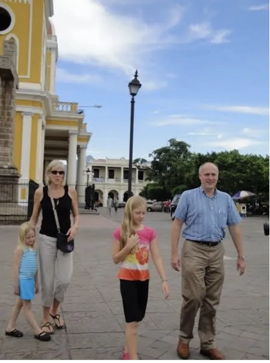A family walks across the central square in Granada, Nicaragua, where the author grew up and saw healthcare in Nicaragua first-hand.