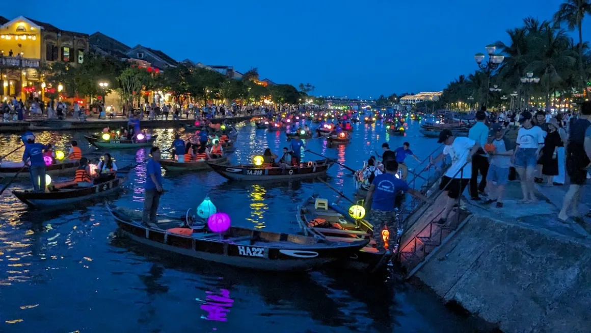 Lantern boats fill the Thu Bon River beside Hoi An’s Ancient Town at night.