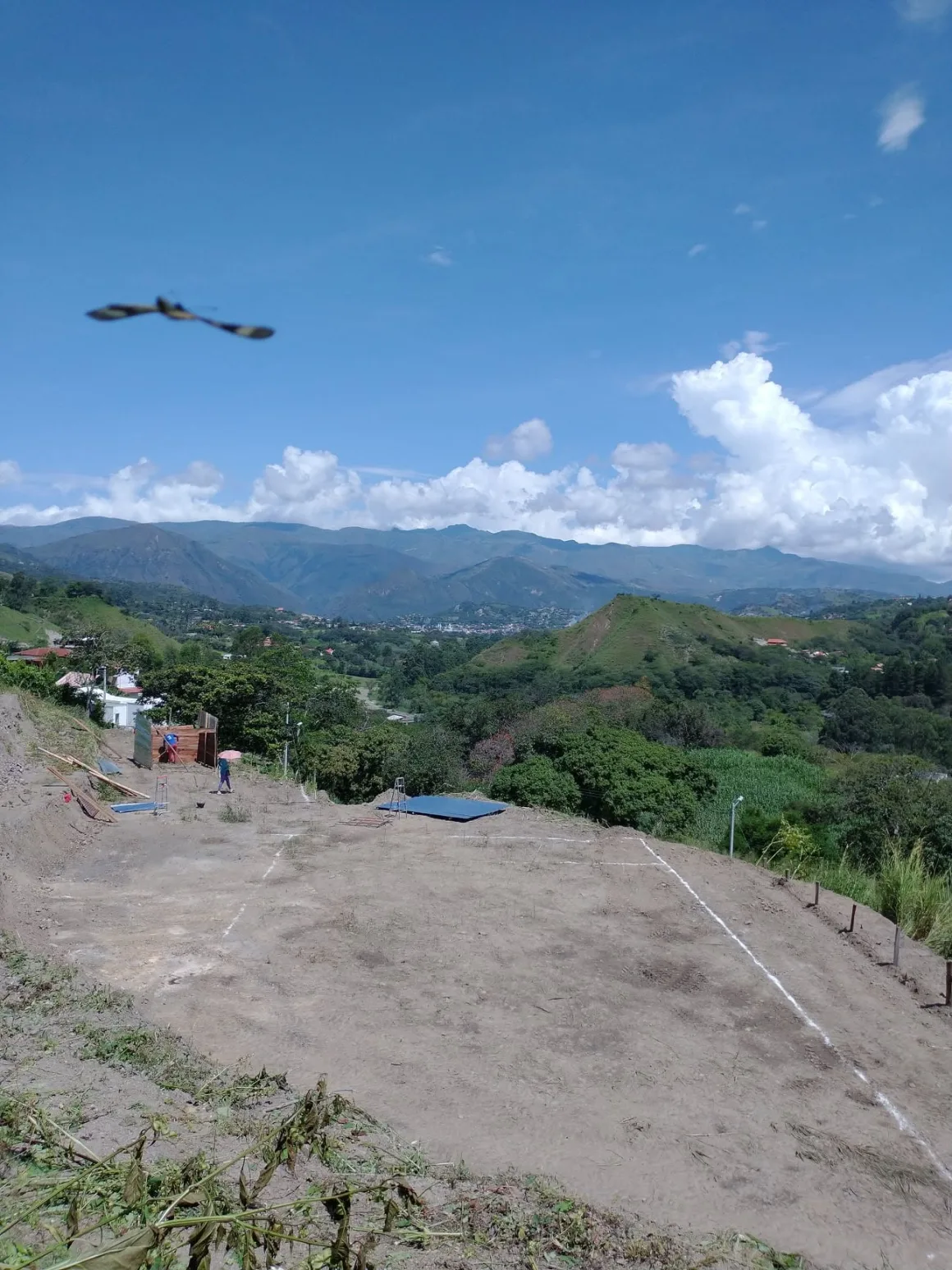 The house footprint marked out in white lines on the cleared plot, overlooking the valley.