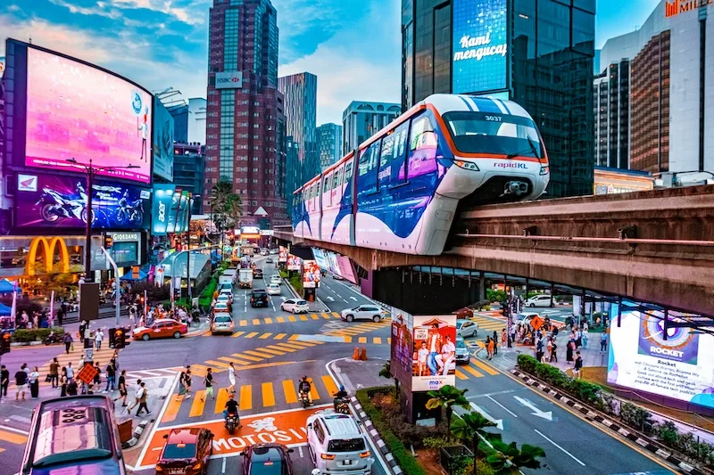 A monorail train passing above the street in Bukit Bintang, Kuala Lumpur.