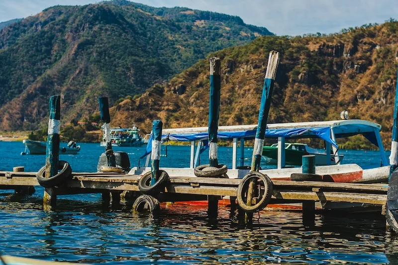 Public boats tied up at a wooden dock, the lake’s main way of getting between villages.
