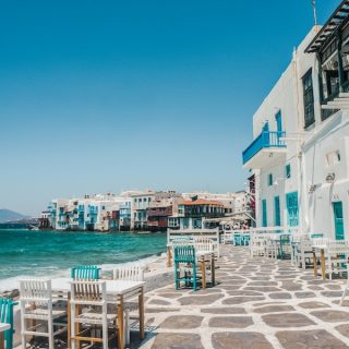 Waterfront cafe tables in Little Venice, Mykonos, Greece, a reminder that expat rule changes 2027 brings are not all bad news.